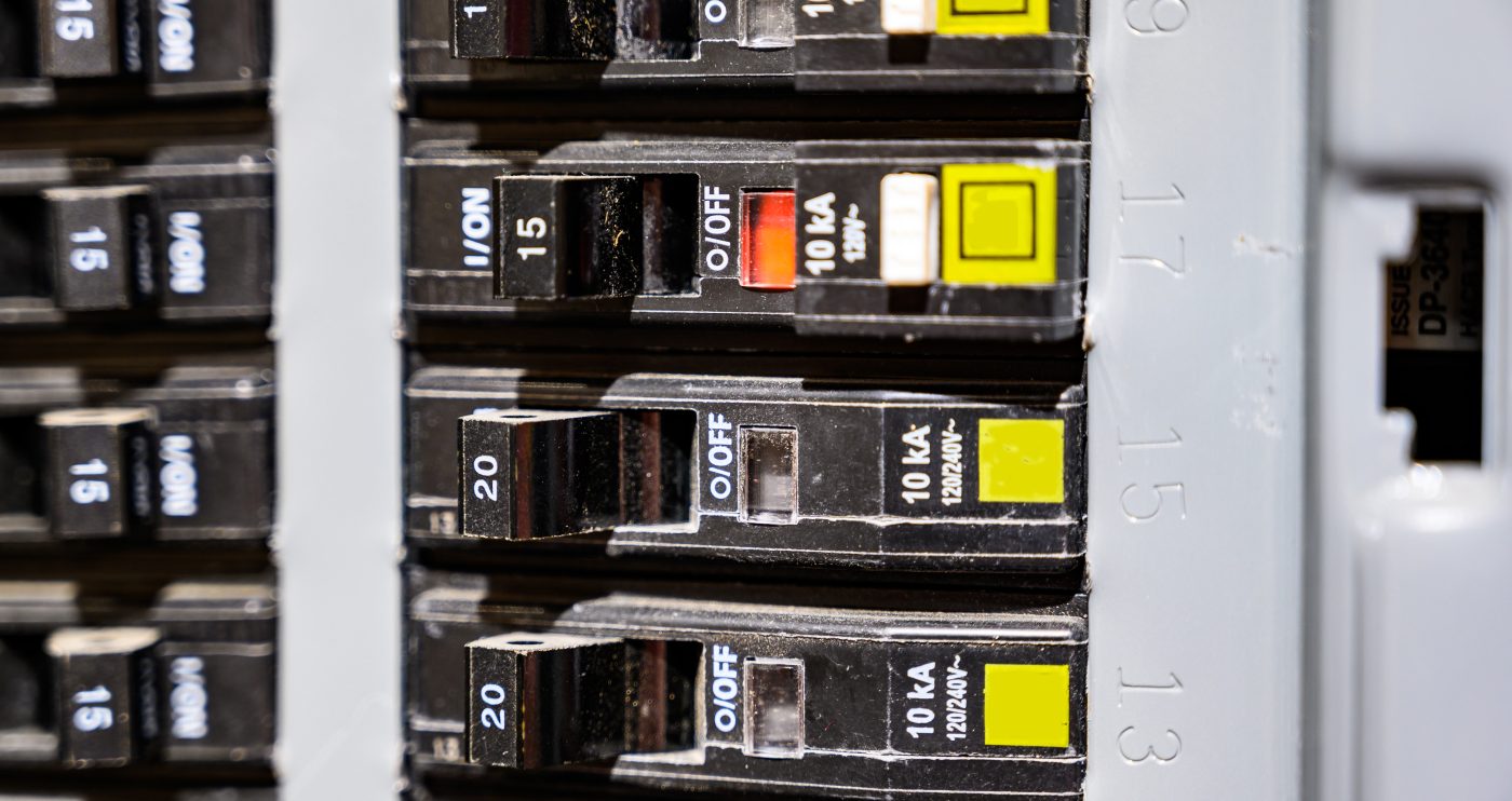 Close-up of breakers in a residential electrical panel, representative of NCIS electrical services.
